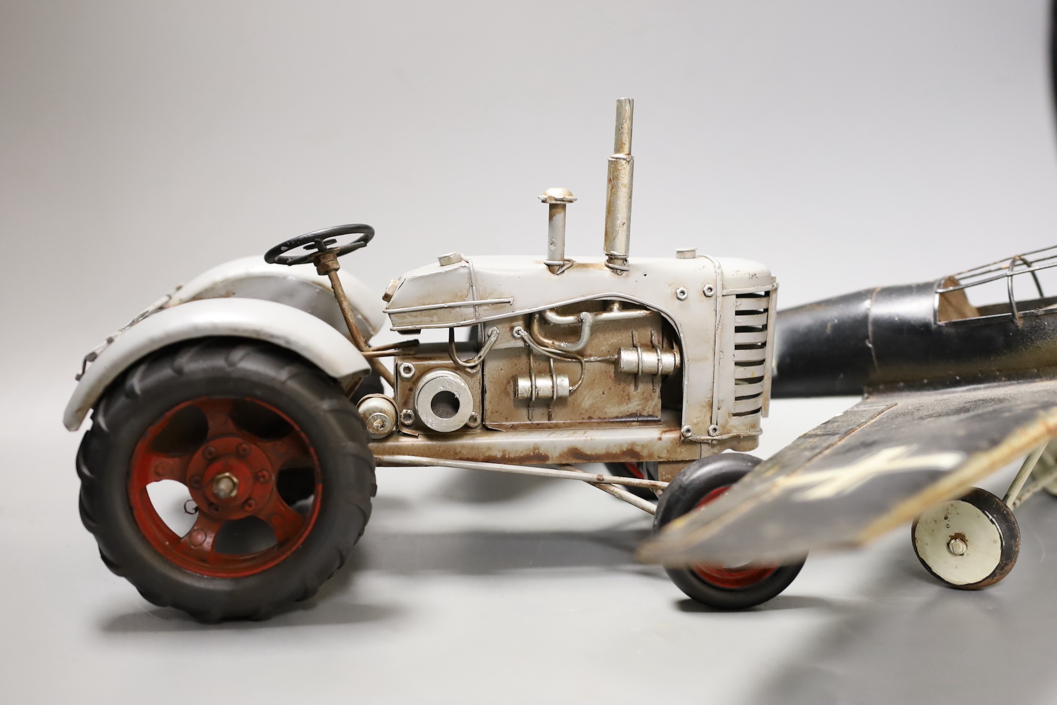 A German tinplate Focke-Wulf model aeroplane, 62cm wingspan, and a tinplate model tractor